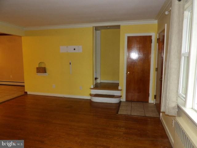 612 S Thomas St, Bedford, PA 15522 - unfurnished room featuring radiator, a baseboard radiator, wood finished floors, crown molding, and baseboards