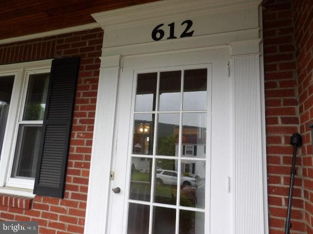 612 S Thomas St, Bedford, PA 15522 - view of exterior entry featuring brick siding