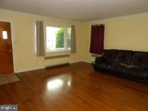 612 S Thomas St, Bedford, PA 15522 - living area with radiator and wood finished floors