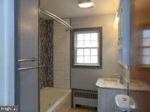 612 S Thomas St, Bedford, PA 15522 - bathroom with radiator,  shower combination, toilet, and vanity