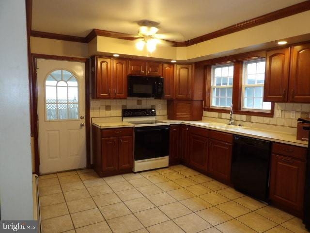 612 S Thomas St, Bedford, PA 15522 - kitchen with black appliances, a sink, light countertops, tasteful backsplash, and crown molding