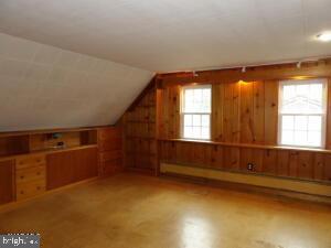 612 S Thomas St, Bedford, PA 15522 - additional living space featuring wood walls, vaulted ceiling, and a baseboard heating unit