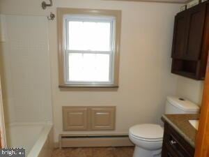 612 S Thomas St, Bedford, PA 15522 - full bath featuring baseboard heating, vanity, toilet, and healthy amount of natural light