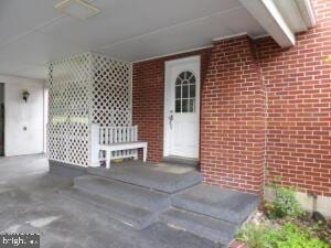 612 S Thomas St, Bedford, PA 15522 - doorway to property featuring brick siding and covered porch