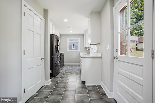 514 Silver Spring Ave, Silver Spring, MD 20910 - laundry room featuring a sink, baseboards, recessed lighting, and dark tile patterned flooring