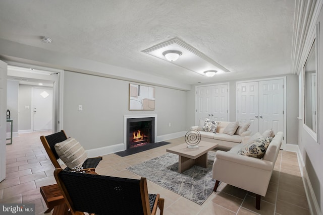 514 Silver Spring Ave, Silver Spring, MD 20910 - tiled living room with a fireplace with flush hearth, a textured ceiling, and baseboards