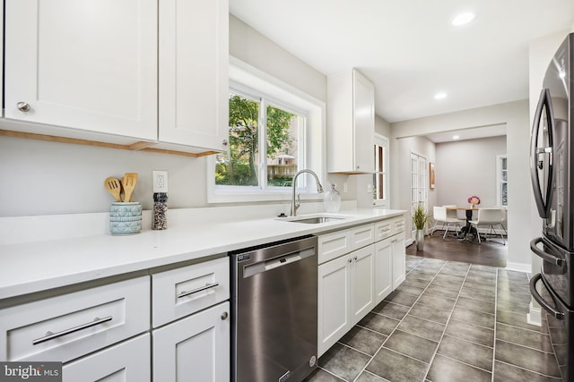 514 Silver Spring Ave, Silver Spring, MD 20910 - kitchen with stainless steel appliances, a sink, white cabinets, recessed lighting, and light countertops