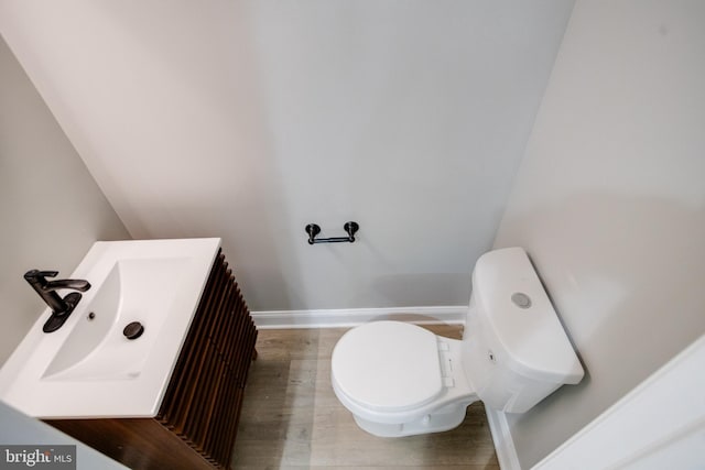 5002 Chalgrove Ave, Baltimore, MD 21215 - half bathroom featuring toilet, wood finished floors, baseboards, and vanity