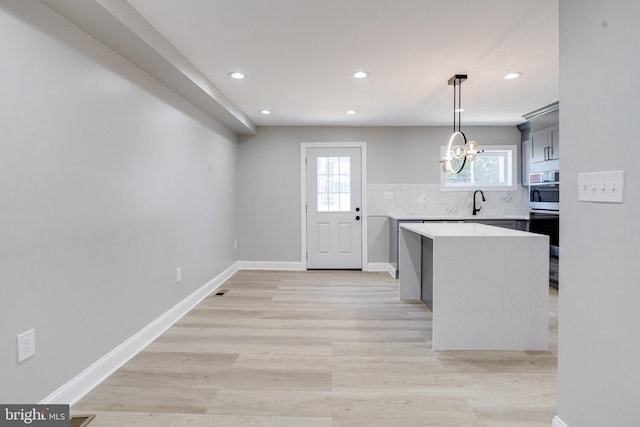 5002 Chalgrove Ave, Baltimore, MD 21215 - kitchen with light countertops, a chandelier, recessed lighting, a kitchen island, and double oven