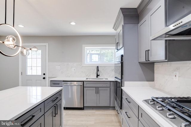 5002 Chalgrove Ave, Baltimore, MD 21215 - kitchen with appliances with stainless steel finishes, a sink, extractor fan, gray cabinetry, and light countertops