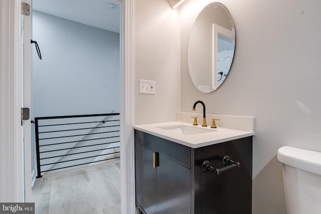5002 Chalgrove Ave, Baltimore, MD 21215 - bathroom with wood finished floors, vanity, and toilet