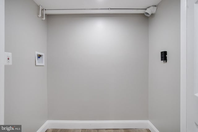 5002 Chalgrove Ave, Baltimore, MD 21215 - laundry room featuring hookup for a washing machine, light wood-style flooring, and baseboards