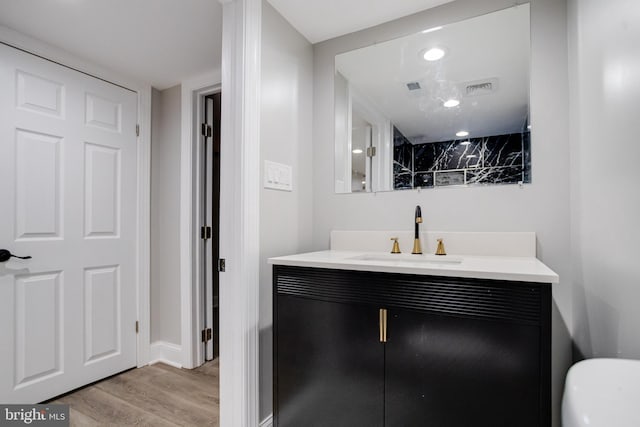 5002 Chalgrove Ave, Baltimore, MD 21215 - bathroom with vanity, wood finished floors, and baseboards