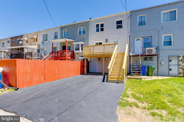 5002 Chalgrove Ave, Baltimore, MD 21215 - townhome / multi-family property featuring stairs, a residential view, a wooden deck, and stucco siding