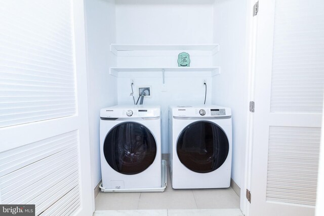 618 N American St, Philadelphia, PA 19123 - laundry area with washing machine and clothes dryer and light tile patterned flooring