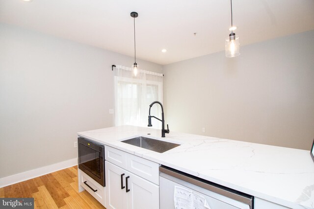 618 N American St, Philadelphia, PA 19123 - kitchen featuring black microwave, a sink, dishwasher, white cabinetry, and decorative light fixtures