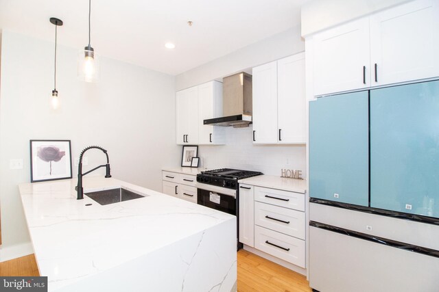 618 N American St, Philadelphia, PA 19123 - kitchen featuring fridge, wall chimney range hood, a sink, black range with gas cooktop, and white cabinets