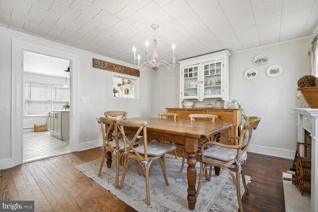 389 Cypress St, Millington, MD 21651 - dining space with a chandelier, hardwood / wood-style floors, baseboards, and crown molding