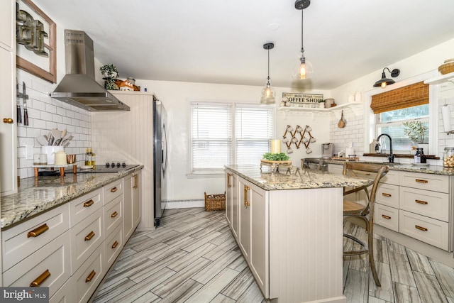 389 Cypress St, Millington, MD 21651 - kitchen with island exhaust hood, stainless steel refrigerator with ice dispenser, decorative backsplash, a kitchen island, and a sink