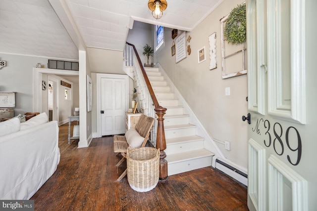 389 Cypress St, Millington, MD 21651 - stairs featuring a baseboard heating unit, hardwood / wood-style floors, baseboards, and vaulted ceiling