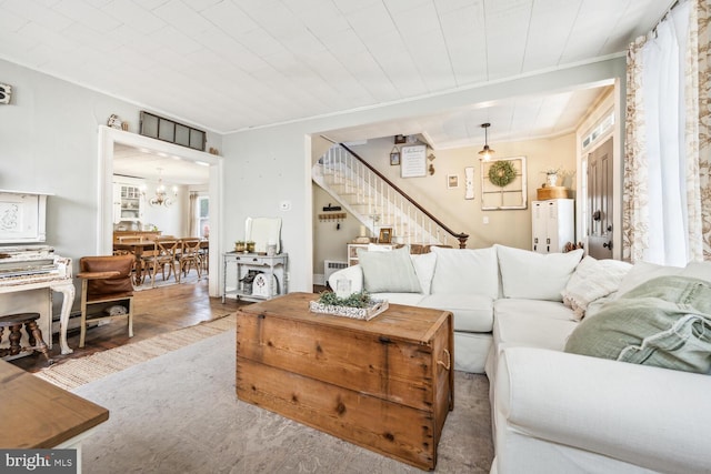 389 Cypress St, Millington, MD 21651 - living area featuring ornamental molding, stairs, a chandelier, wood finished floors, and radiator