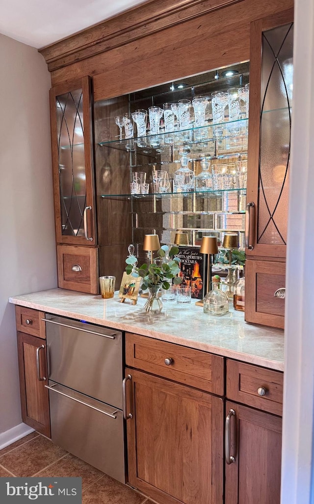 10 Malibu Ct, Towson, MD 21204 - indoor dry bar with dark tile patterned flooring, refrigerator, and stainless steel dishwasher