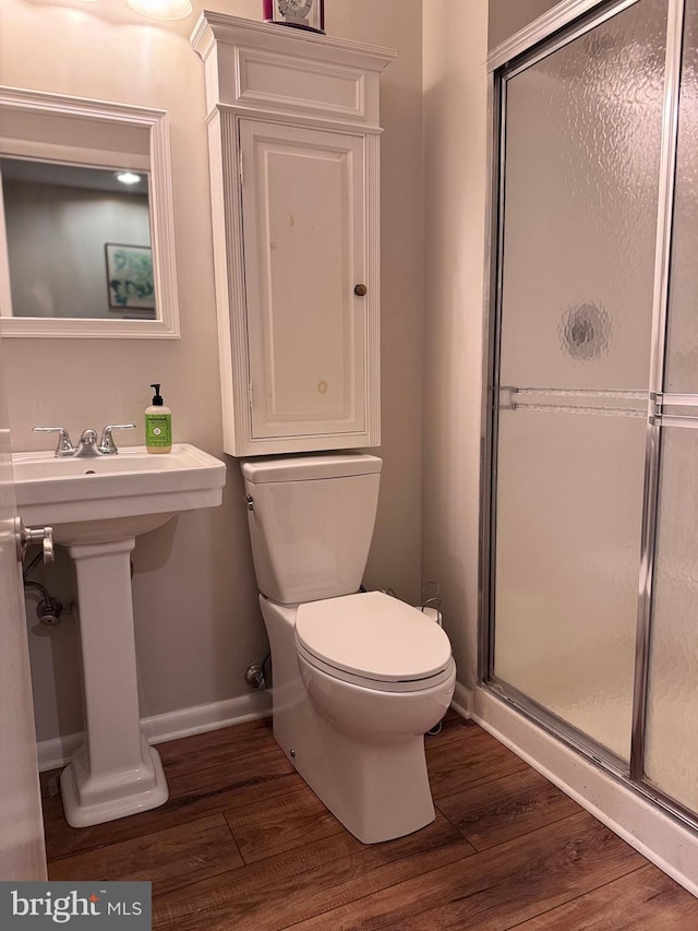 10 Malibu Ct, Towson, MD 21204 - full bathroom featuring toilet, wood finished floors, a stall shower, baseboards, and a sink