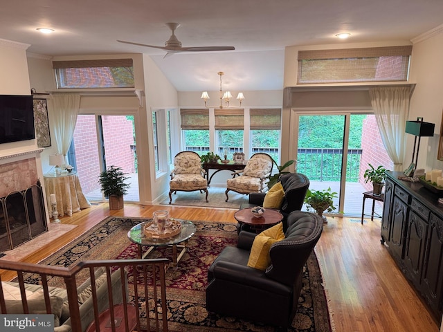 10 Malibu Ct, Towson, MD 21204 - living area with ceiling fan, wood finished floors, a fireplace with flush hearth, ornamental molding, and a chandelier