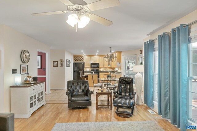 14 Patriot Ln, Palmyra, VA 22963 - living area featuring light wood-style floors, ceiling fan, baseboards, and a chandelier