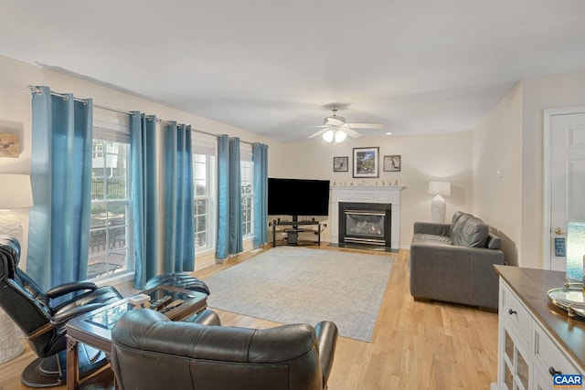 14 Patriot Ln, Palmyra, VA 22963 - living area with a fireplace with flush hearth, light wood finished floors, and a ceiling fan