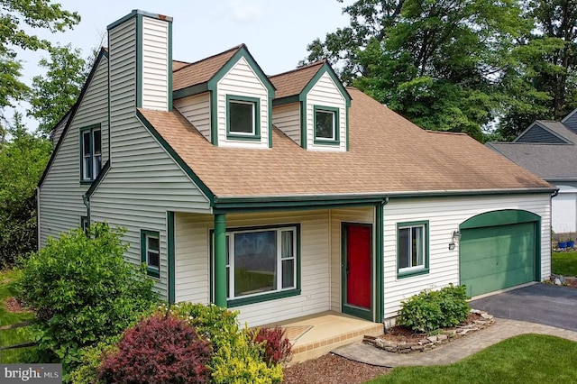 5762 Lichenbark Cir, New Market, MD 21774 - new england style home with an attached garage, roof with shingles, driveway, a chimney, and covered porch