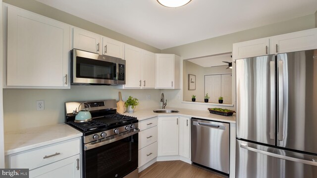 1703 Hopkins Ct, Southampton, PA 18966 - kitchen with stainless steel appliances, white cabinetry, and light wood-style floors