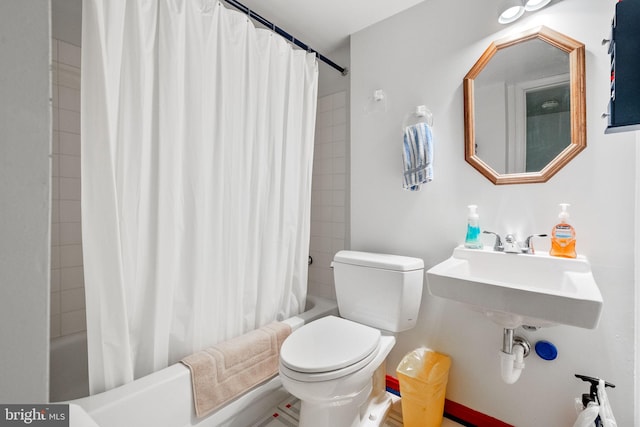 49 Huntley Ct, Sterling, VA 20165 - bathroom featuring toilet, shower / bath combo with shower curtain, and a sink