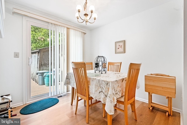 49 Huntley Ct, Sterling, VA 20165 - dining space with a chandelier, light wood finished floors, and baseboards