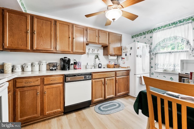 49 Huntley Ct, Sterling, VA 20165 - kitchen with white appliances, a sink, wallpapered walls, light wood-style flooring, and brown cabinets