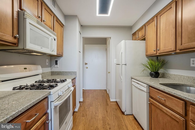 600 Roosevelt Blvd Unit 510, Falls Church, VA 22044 - kitchen with white appliances, light wood-type flooring, brown cabinets, and light stone counters