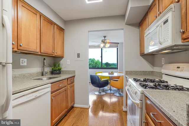600 Roosevelt Blvd Unit 510, Falls Church, VA 22044 - kitchen featuring white appliances, light wood finished floors, brown cabinetry, a ceiling fan, and light stone countertops