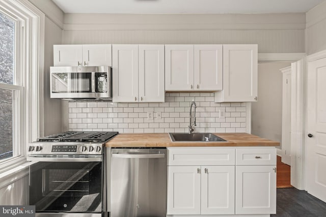 327 W Fourth St, Media, PA 19063 - kitchen featuring wooden counters, appliances with stainless steel finishes, a sink, white cabinetry, and backsplash
