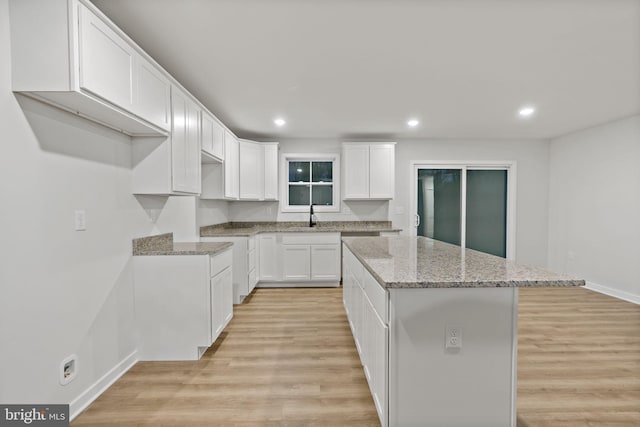 183 Silage Ln, Berkeley Springs, WV 25411 - kitchen featuring a kitchen island, recessed lighting, light wood-type flooring, light stone counters, and white cabinets