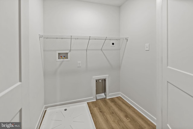 183 Silage Ln, Berkeley Springs, WV 25411 - washroom with electric dryer hookup, washer hookup, wood finished floors, and baseboards