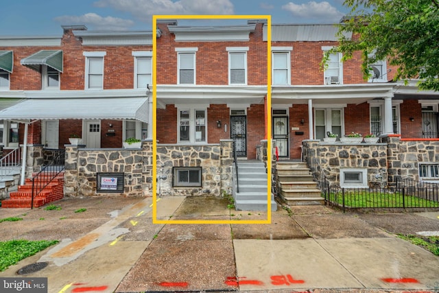 1229 N Potomac St, Baltimore, MD 21213 - multi unit property with brick siding, covered porch, stone siding, and stairway