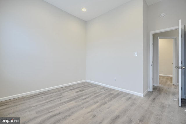 1229 N Potomac St, Baltimore, MD 21213 - unfurnished room featuring baseboards, light wood-type flooring, vaulted ceiling, a smoke detector, and recessed lighting