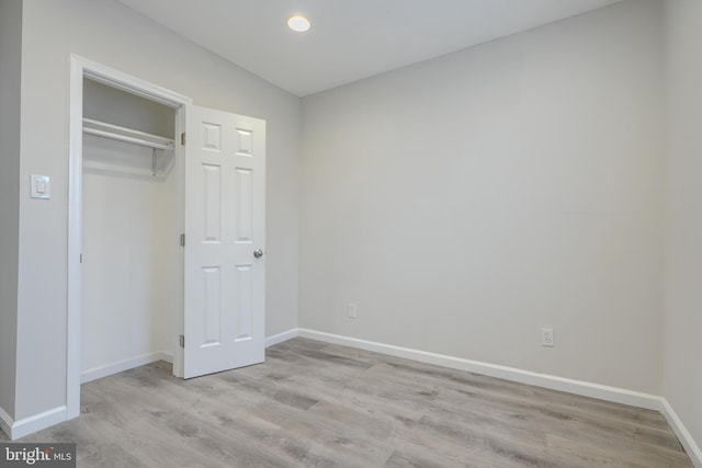 1229 N Potomac St, Baltimore, MD 21213 - unfurnished bedroom with wood finished floors, baseboards, and a closet