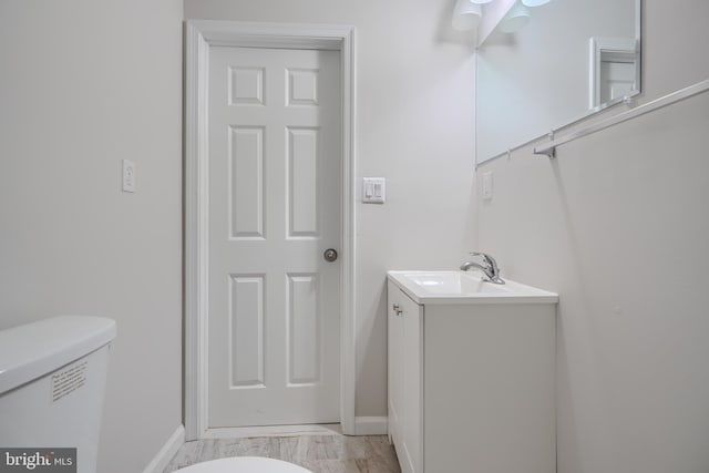 1229 N Potomac St, Baltimore, MD 21213 - bathroom featuring vanity, baseboards, toilet, and marble look tile flooring