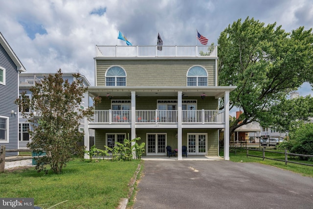107 Swedes St, Dewey Beach, DE 19971 - back of property featuring french doors, a balcony, and asphalt driveway