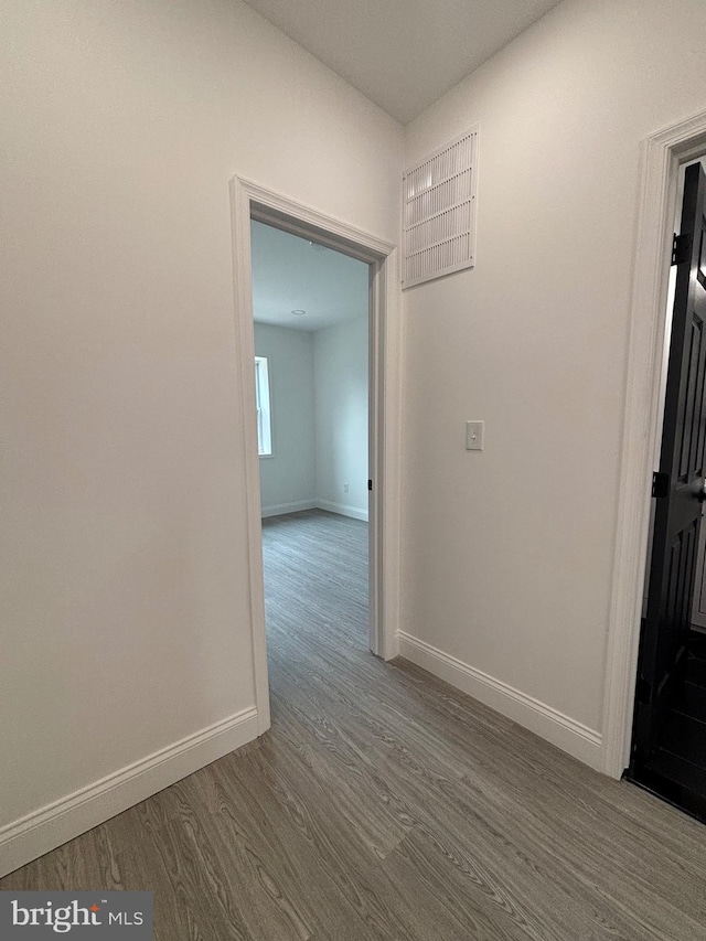 1748 N Chester St, Baltimore, MD 21213 - corridor with dark wood-type flooring and baseboards