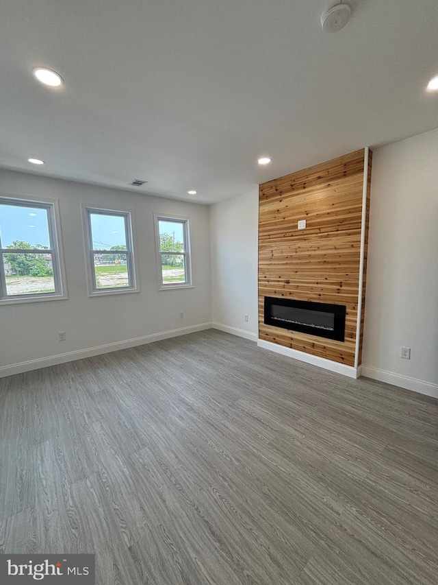 1748 N Chester St, Baltimore, MD 21213 - unfurnished living room with a glass covered fireplace, recessed lighting, wood finished floors, and baseboards