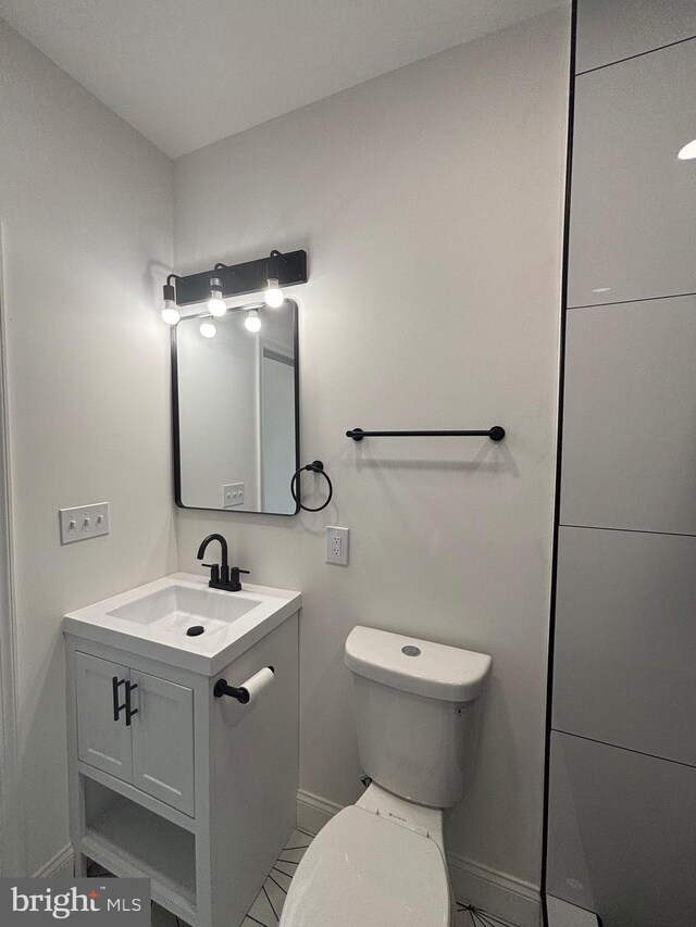 1748 N Chester St, Baltimore, MD 21213 - bathroom with vanity, baseboards, and toilet