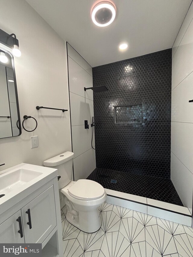 1748 N Chester St, Baltimore, MD 21213 - full bath with a tile shower, toilet, vanity, and tile patterned flooring