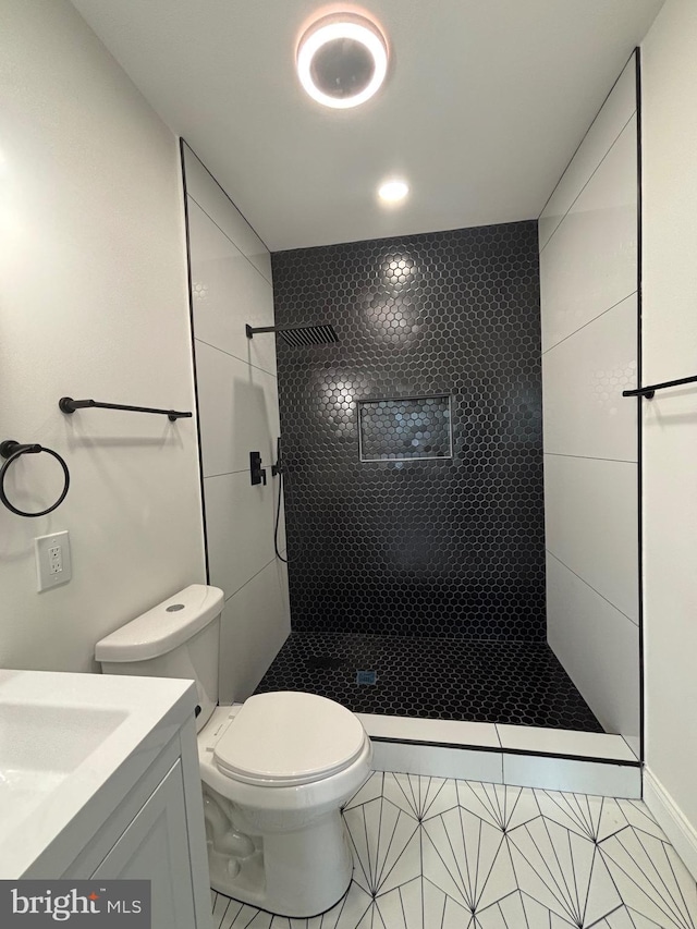 1748 N Chester St, Baltimore, MD 21213 - bathroom featuring tiled shower, vanity, toilet, and tile patterned floors